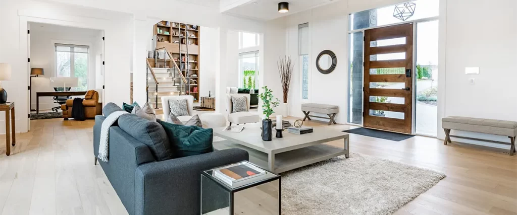 Bright modern living room with open layout and wooden front door