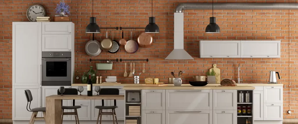 Modern kitchen with exposed brick walls, white cabinetry, industrial lighting, and rustic wooden ceiling beams.