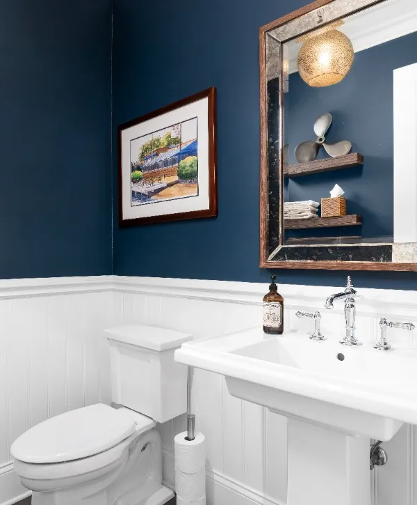 A bathroom featuring blue walls and white trim, creating a fresh and clean atmosphere