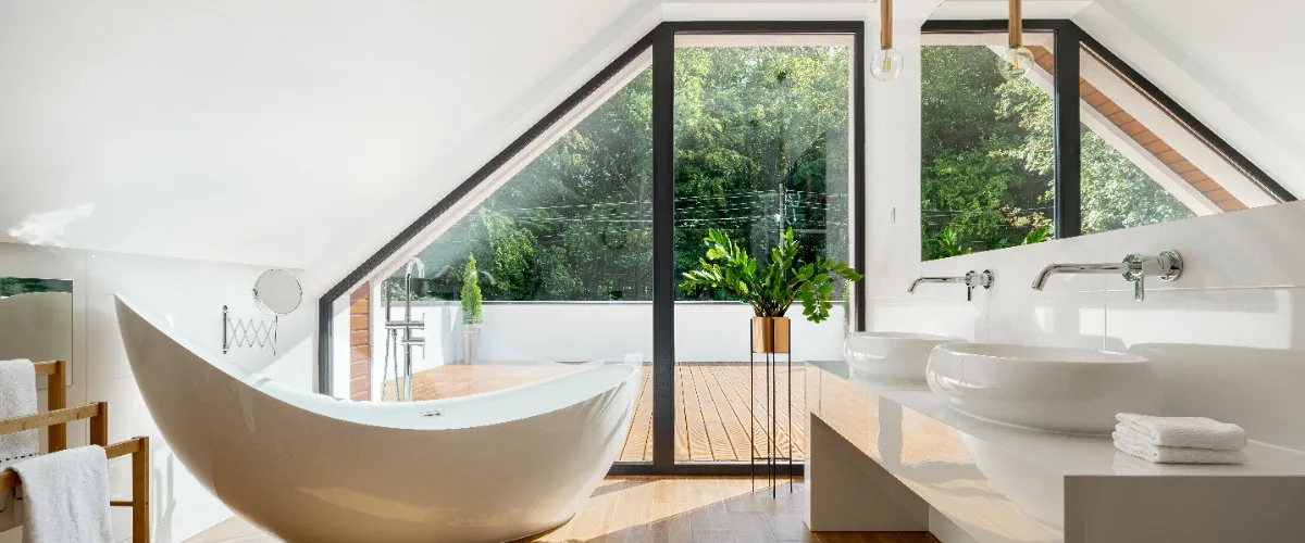 A bright bathroom featuring a large window and a spacious bathtub