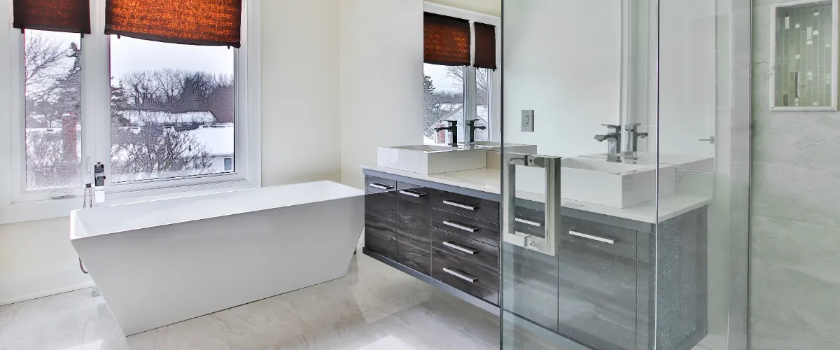 A stylish bathroom showcasing a glass shower door and minimalist design elements.