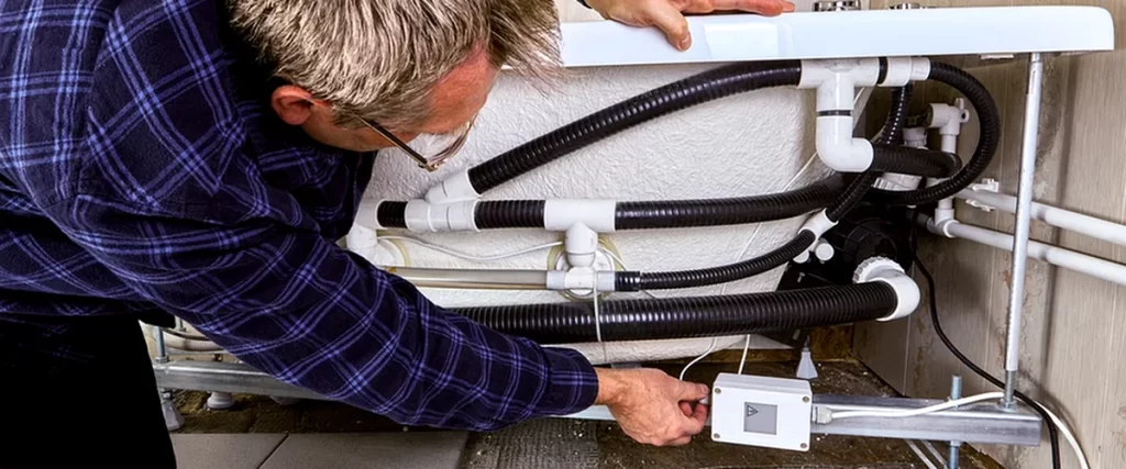 electrical rewiring marlboro nj bathroom remodeling professional contractor inspecting bathtub plumbing connections ensuring expert installation quality
