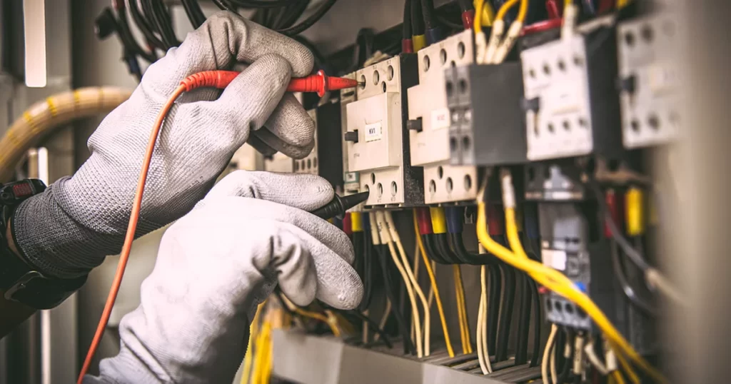 electrical rewiring marlboro nj bathroom remodeling professional technician wearing protective gloves inspects electrical panel wiring connections
