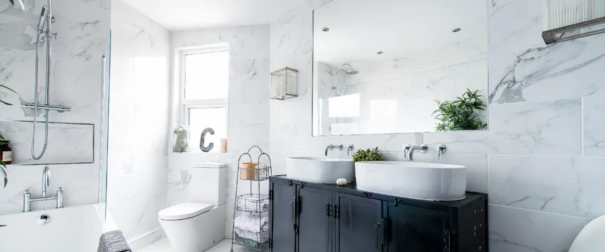 a modern bathroom featuring a white marble aesthetic and a black vanity