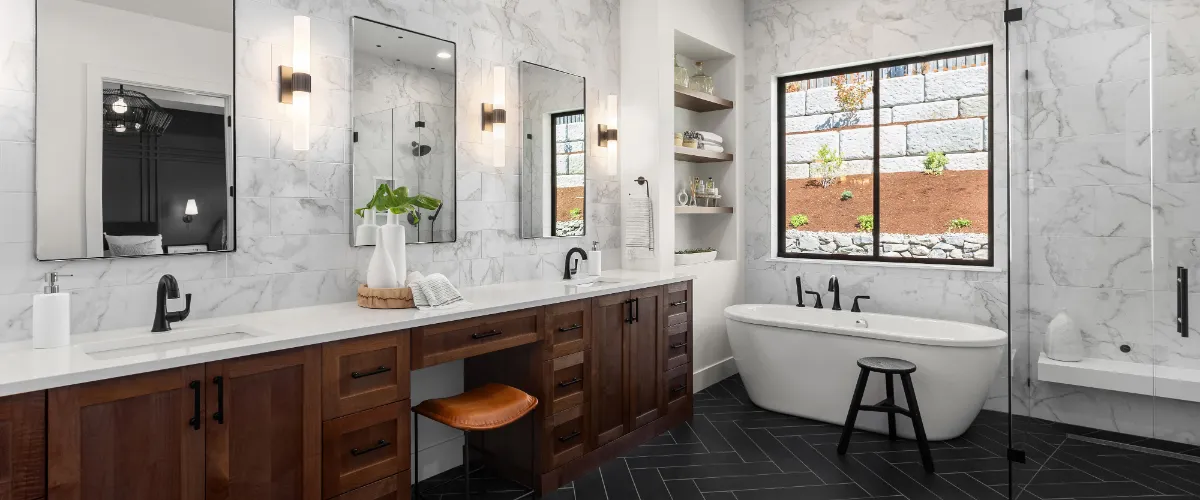 a modern, recently remodeled bathroom featuring a blend of dark wood cabinetry and white marble tiling
