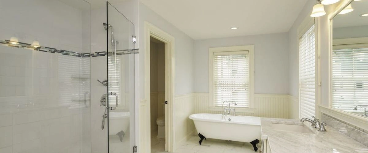 traditional bathroom with white wainscoting and clawfoot tub