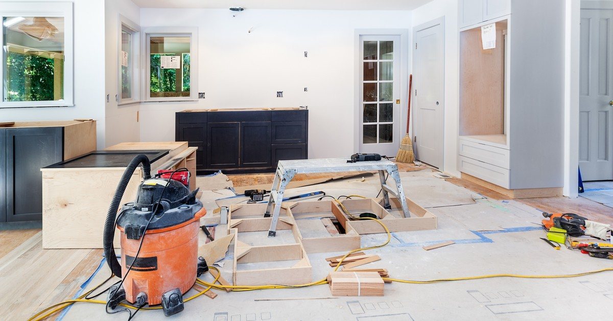 A work-in-progress shot of a kitchen renovation addressing Middletown, NJ kitchen layout issues with shop vacs, tools, and new cabinet frames visible.