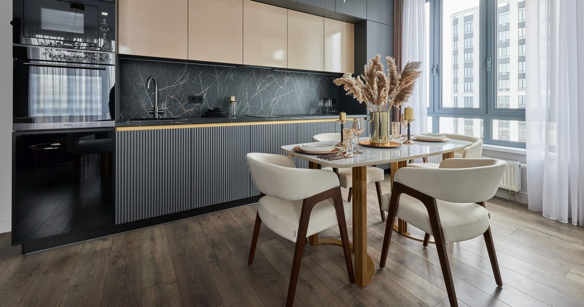 A luxury open-concept kitchen and dining area at Bell Works featuring ribbed cabinetry and acoustic textures to control kitchen noise.