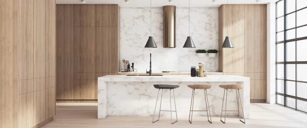 A bright, minimalist kitchen with a large white marble island, light wood cabinetry, and floor-to-ceiling windows in a soundproof kitchen.