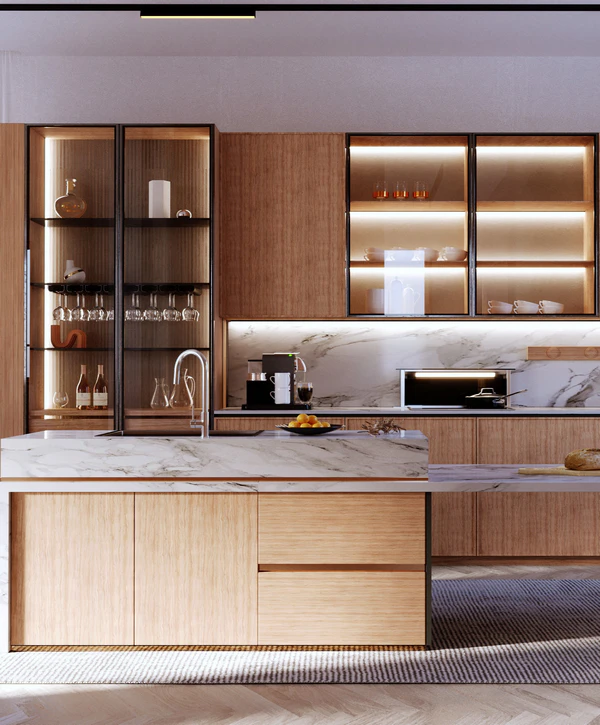 Modern kitchen remodeling in Aberdeen, NJ featuring light wood cabinetry, white marble countertops and backsplash, and black-framed glass display cabinets with warm interior lighting.